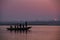 Six pilgrimage men praying to sunrise on a small boat in Varanasi river , India