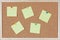Six post-it notes with pins sticked on corkboard