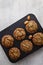 six prepared muffins in a baking dish on the table