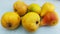 Six ripe yellow pears atop scratched table