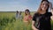 Six schoolgirls posing with flowers in a rapeseed field.