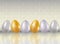 A six shining dyed in metallic gold, silve, platinum colors chicken eggs on white brick wall background with reflaction. Healthy f