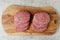 Six simple beef uncooked burgers on a wooden board. Meat industry product. Fast fool meal