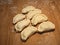 Six uncooked dumplings on the wooden kitchen board