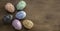 Six unusal embossed carved Art Nouveau style Easter eggs on a dark wooden background.