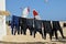 Six wetsuits hanging out to dry on Corralejo beach, Fuerteventura