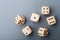 Six wooden dice on gray table top view. Board game. Gambling devices.