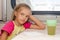 Six-year girl thoughtfully and tired sitting on train at the table in the second-class compartment