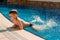 Six-year-old boy swimming in the outdoor pool at the hotel