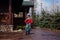 Six-year-old boy in a warm red jacket rides a children`s two-wheeled bike outdoors