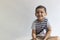 Six years boy portrait. Innocent smiling little boy on grey background. Little boy contorts his face. People, childhood lifestyle