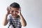 Six years boy portrait. Innocent smiling little boy on grey background. Little boy contorts his face. People, childhood lifestyle