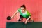 Sixteen year old Caucasian teen girl holding a ping pong paddle, top view