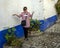 Sixty-three year old female Korean tourist with a Covid mask and a coffee in Obidos, Portugal.