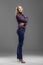 Size plus model in blouse and jeans posing in studio