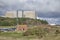 Sizewell A reactor building towering over public toilet block, cafe & flagpole on Sizewell beach in Suffolk