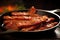 sizzling bacon strips in non-stick skillet