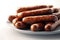 Sizzling Fried Sausages on White Background for Food Blogs and Menus.