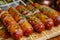 Sizzling Grilled Sausages Garnished with Green Herbs on Wooden Skewers Close Up, Delicious Barbecue Snacks