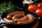 sizzling sausage links next to halved tomatoes