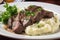 sizzling steak, paired with creamy mashed potatoes and plenty of fresh herbs