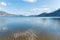 Skaha Lake water reflecting blue sky, sunshine, and mountains