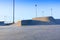 Skate park generic concrete ramps outside with blue sky