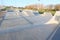 Skate park generic concrete ramps outside with blue sky