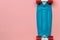 Skateboard cruiser with blue deck and red wheels on pink background, top view with copy-space. Concept of sport lifestyle, culture