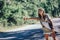 Skateboard girl hitchhiking and stopping car with thumbs up gesture