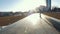 Skateboarder does tricks on the track outdoors in sunset