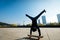 Skateboarder doing a handstand on skateboard