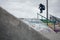 Skateboarder doing a Ollie over the rail in a skatepark