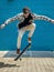 Skateboarder jumping in city