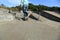 Skateboarder legs riding skateboard at skatepark