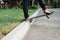 Skateboarder make back slide trick on park