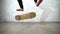 Skateboarder performing skateboard trick - heel flip on concrete. Athlete practicing jump on white background, preparing for