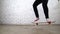 Skateboarder performing skateboard trick in the studio. Athlete practicing stunt jump on yellow background, preparing for