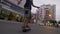 Skateboarder rides on the road and doing tricks