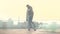 Skateboarder riding outdoors at sunset. Handsome guy riding on a skateboard with green smoke. Outdoors