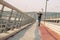 Skateboarder skates over a city bridge. Free ride street skateboarding