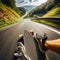 Skateboarder takes an exhilarating ride down a winding country road