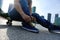 Skateboarder tying shoelace at skate park