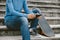 Skateboarder use smartphone on city stairs