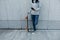 Skateboarder using smartphone leaning on wall in city