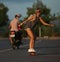 Skateboarders ride skateboard at sunset