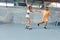 Skateboarding. Couple In Casual Outfit Riding On Skateboard At Skatepark