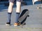 Skateboarding - detail of skateboard and legs.