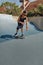 Skateboarding. Man In Urban Outfit Riding On Skateboard On Concrete Ramp At Skatepark