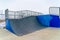 Skateboarding ramp with snow and sky background